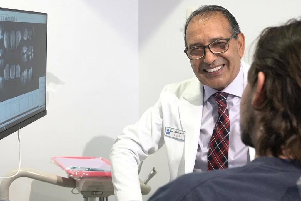 Patient looking at digital smile rendering with dentist